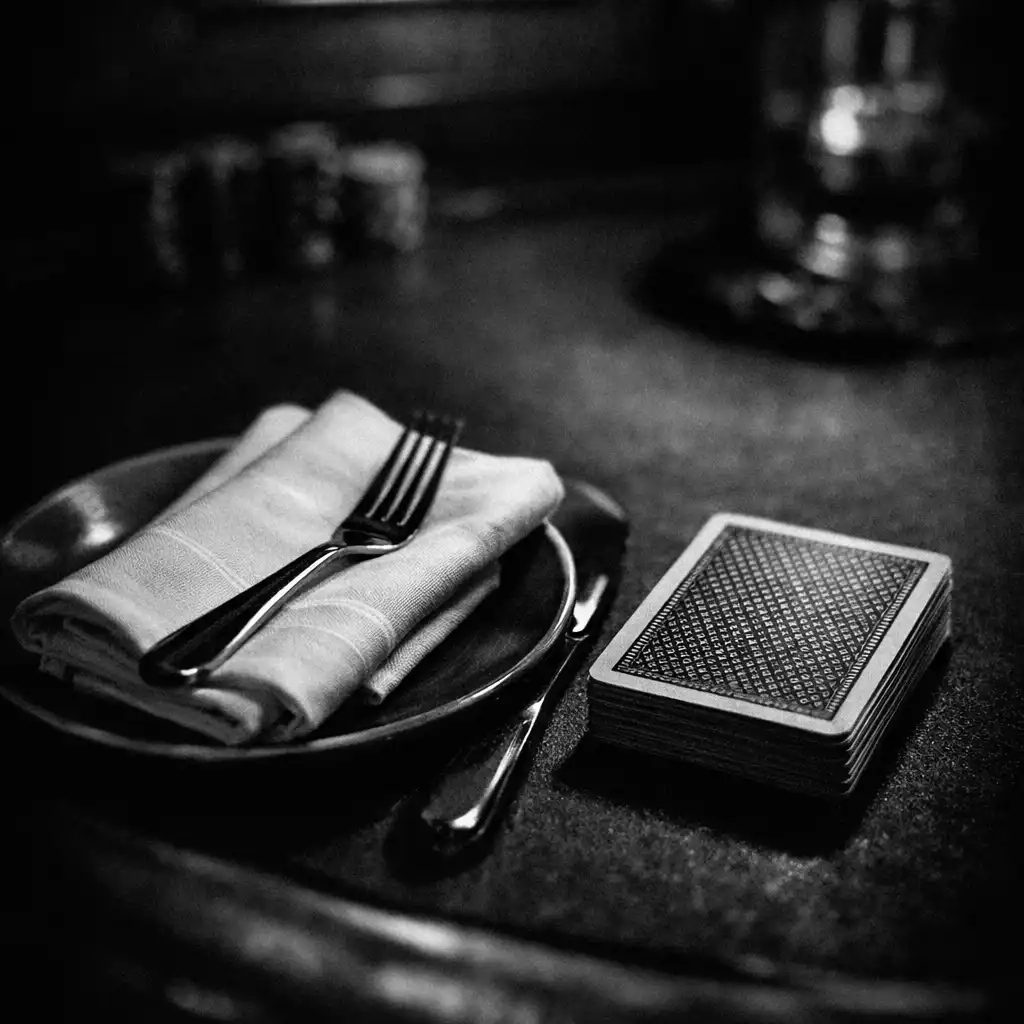 A close-up of a poker table setting with a folded napkin and playing cards